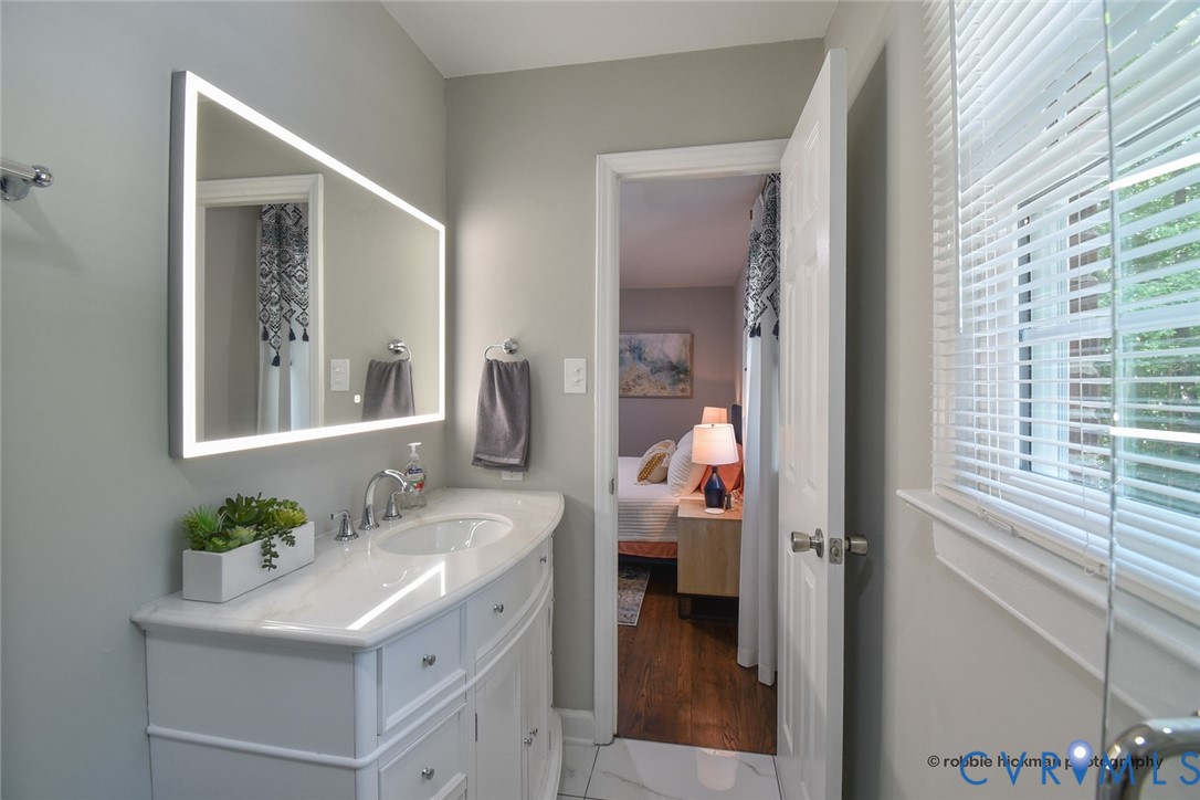 5180 Bemiss Road Richmond, VA 23234 - Photo 14 of 31 a en suite bathroom with a sink and a mirror