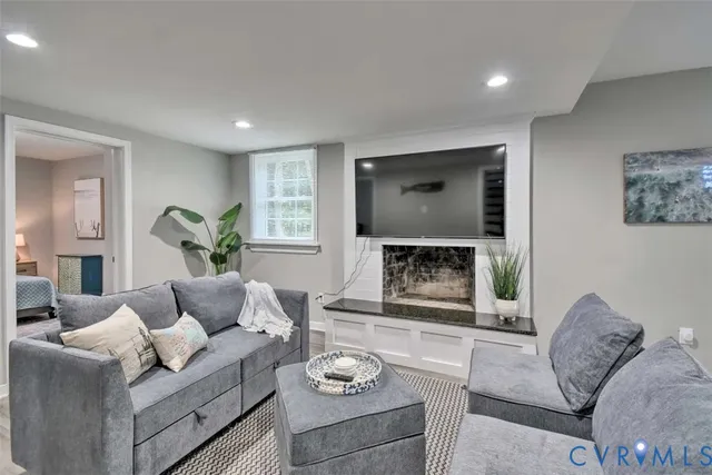 a living room with furniture and a fireplace