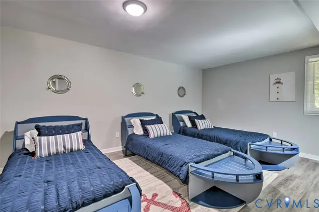 a bedroom with a bed and a wooden floor