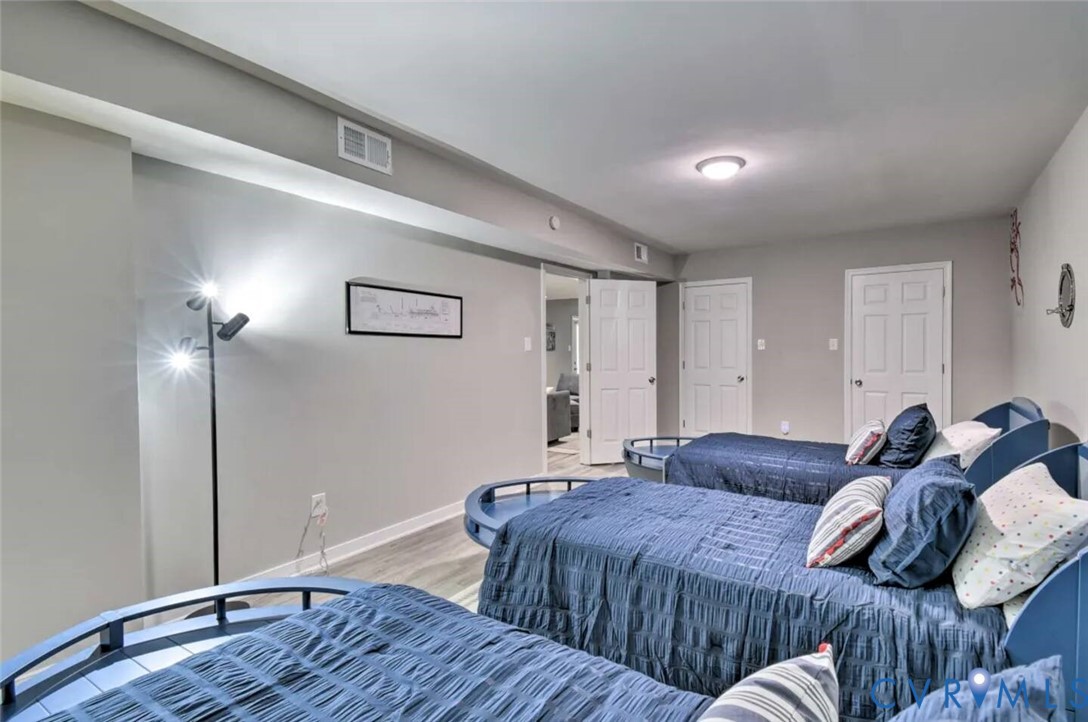 5180 Bemiss Road Richmond, VA 23234 - Photo 25 of 31 a bedroom with a bed and a wooden floor