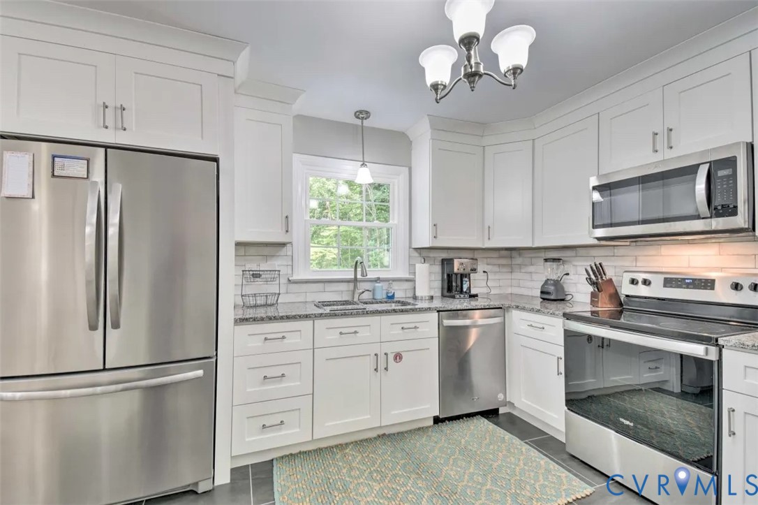5180 Bemiss Road Richmond, VA 23234 - Photo 7 of 31 a kitchen with stainless steel appliances granite countertop a refrigerator a stove a sink and a microwave