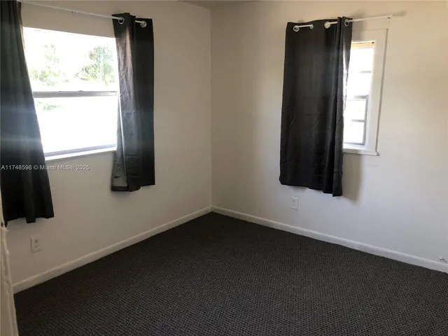 a view of an empty room and a window