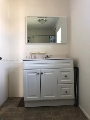 a bathroom with a sink a vanity and mirror
