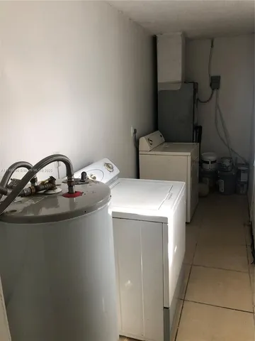 a close view of sink a washer and dryer
