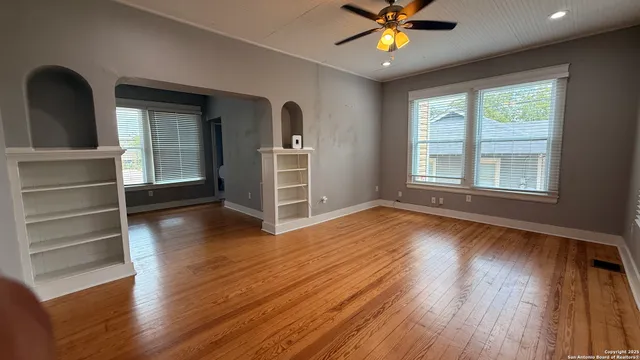 wooden floor in an empty room with a window