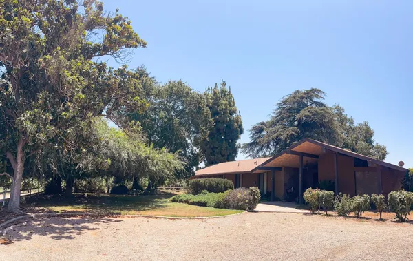 an aerial view of a house with a yard and lake view
