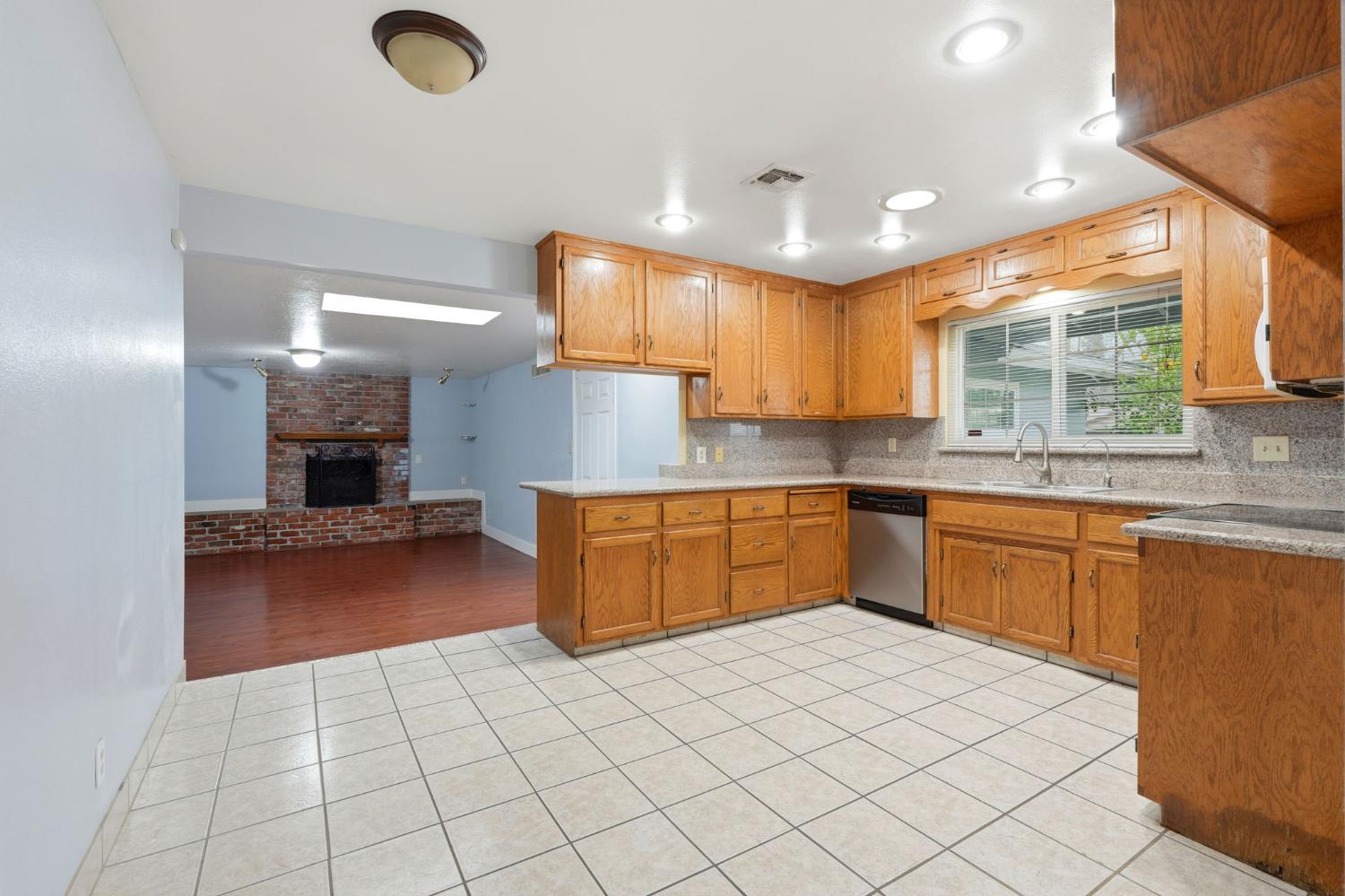 2826 East Hampton Way Fresno, CA 93726 - Photo 12 of 33 a kitchen with a sink cabinets and window