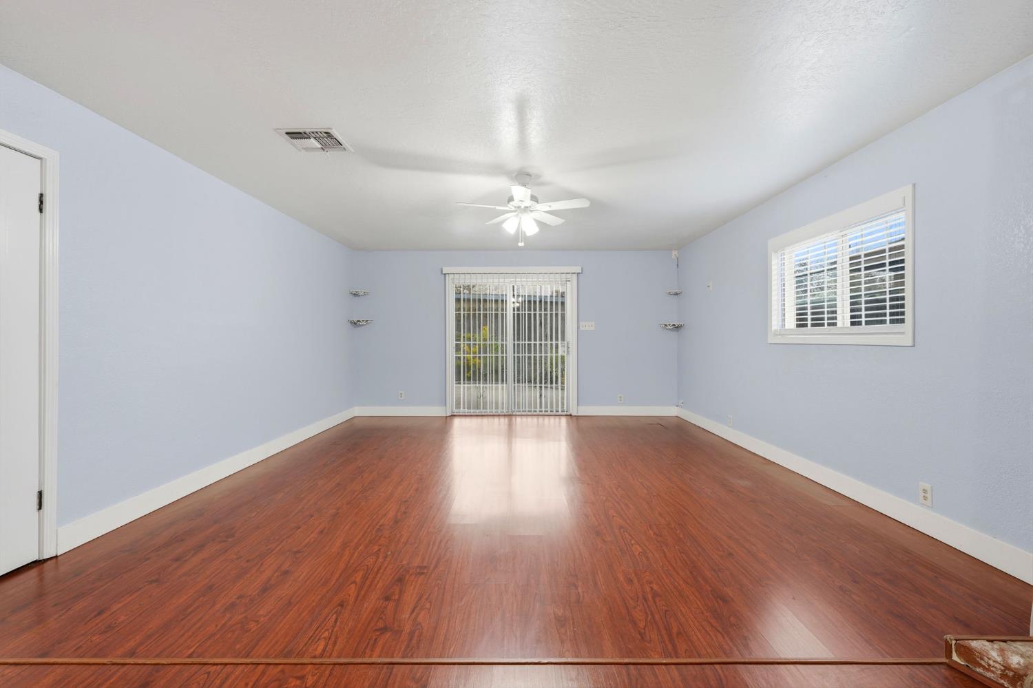 2826 East Hampton Way Fresno, CA 93726 - Photo 17 of 33 a view of an empty room with wooden floor and a window