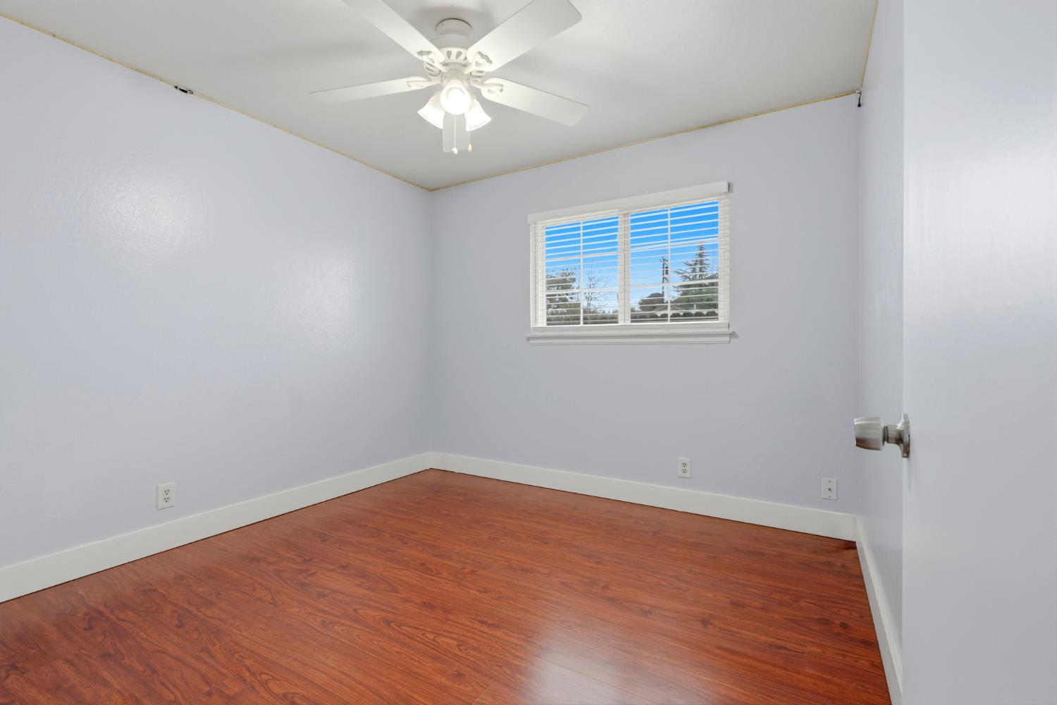 2826 East Hampton Way Fresno, CA 93726 - Photo 18 of 33 wooden floor in an empty room with a window