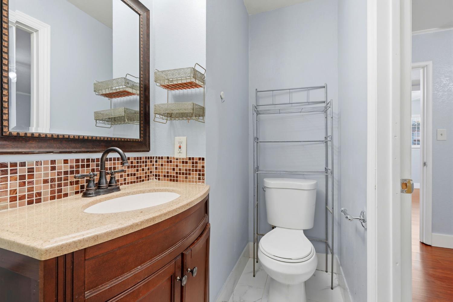 2826 East Hampton Way Fresno, CA 93726 - Photo 24 of 33 a bathroom with a sink toilet and a mirror