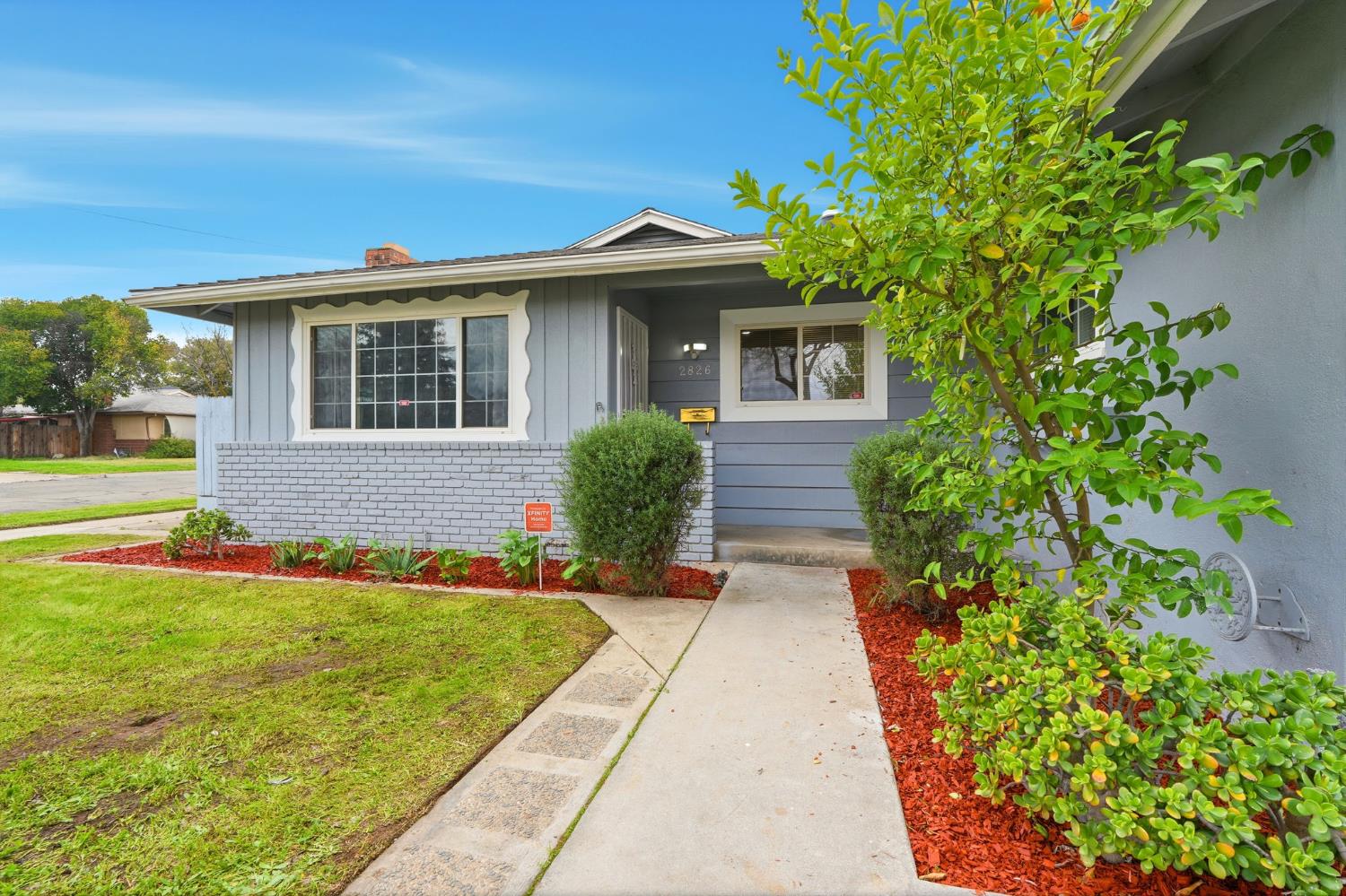 2826 East Hampton Way Fresno, CA 93726 - Photo 5 of 33 a front view of a house with a yard