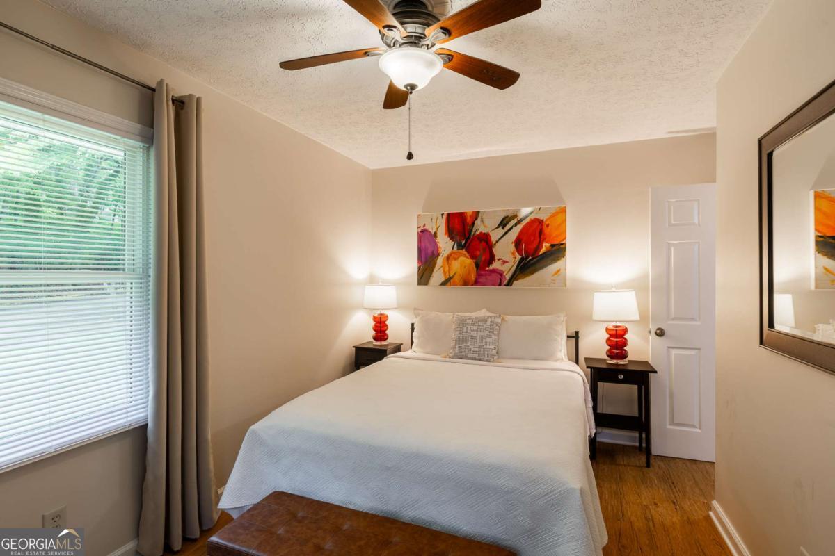 168 Pearl Street Athens, GA 30601 - Photo 19 of 43 a bedroom with a bed and a chandelier
