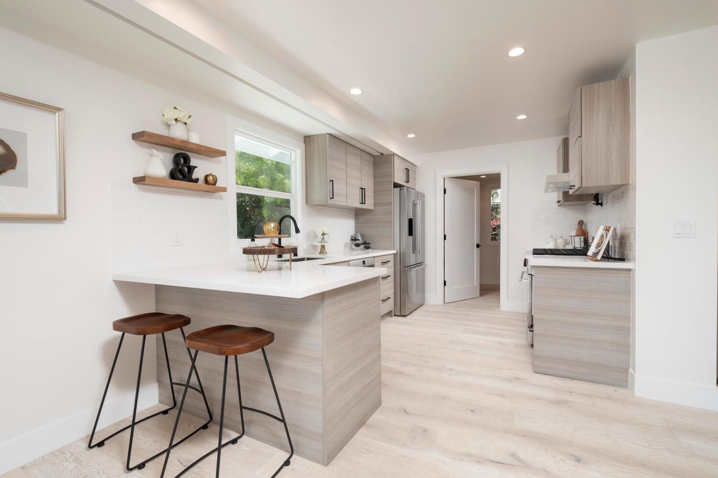 411 Ridge Road San Carlos, CA 94070 - Photo 12 of 40 a kitchen with kitchen island a sink cabinets and stainless steel appliances