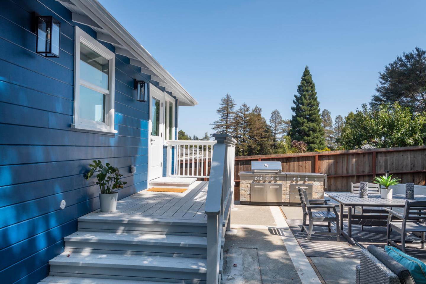 411 Ridge Road San Carlos, CA 94070 - Photo 28 of 40 a view of a patio with table and chairs potted plants with wooden floor and fence