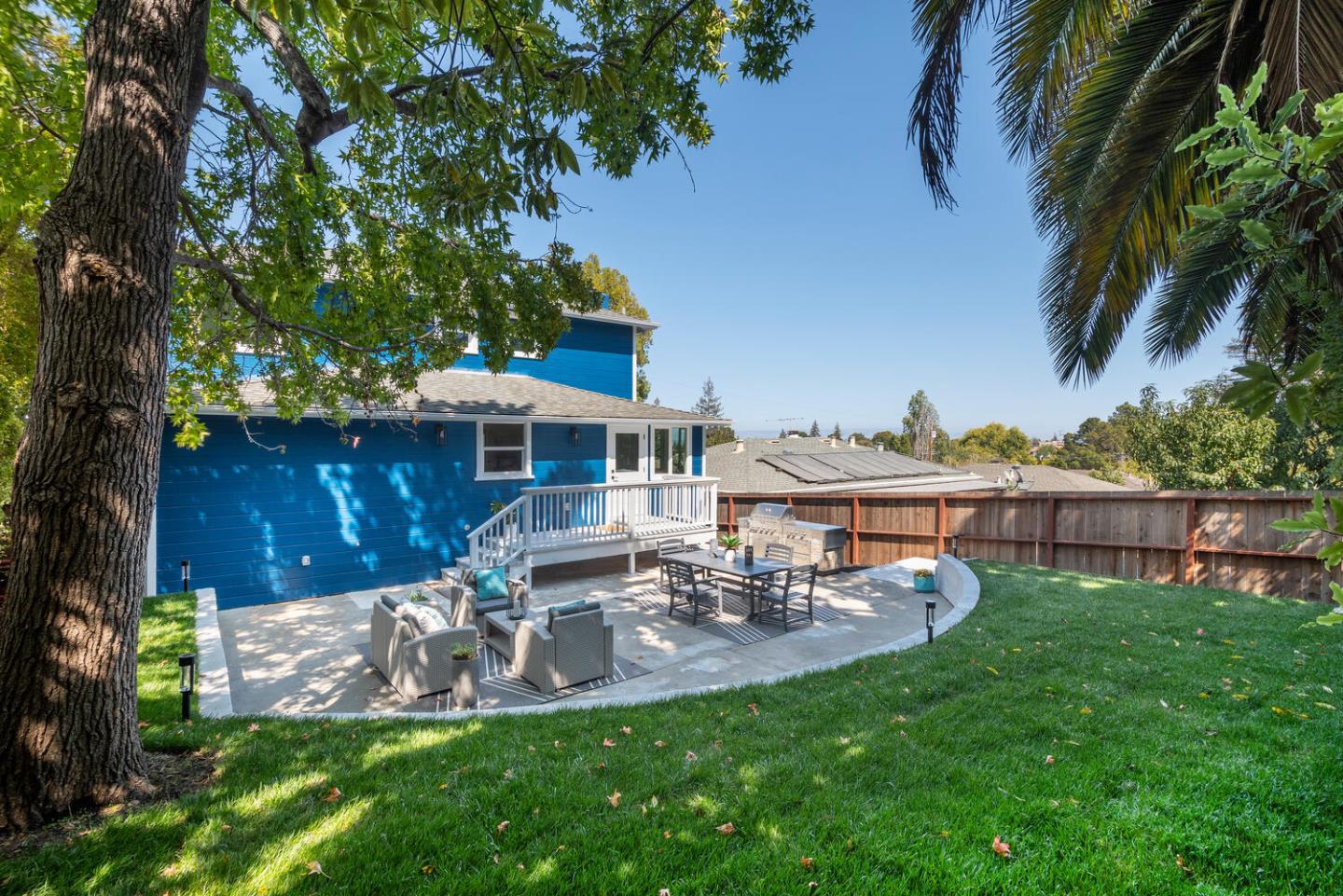 411 Ridge Road San Carlos, CA 94070 - Photo 32 of 40 a view of a patio with table and chairs potted plants and large tree