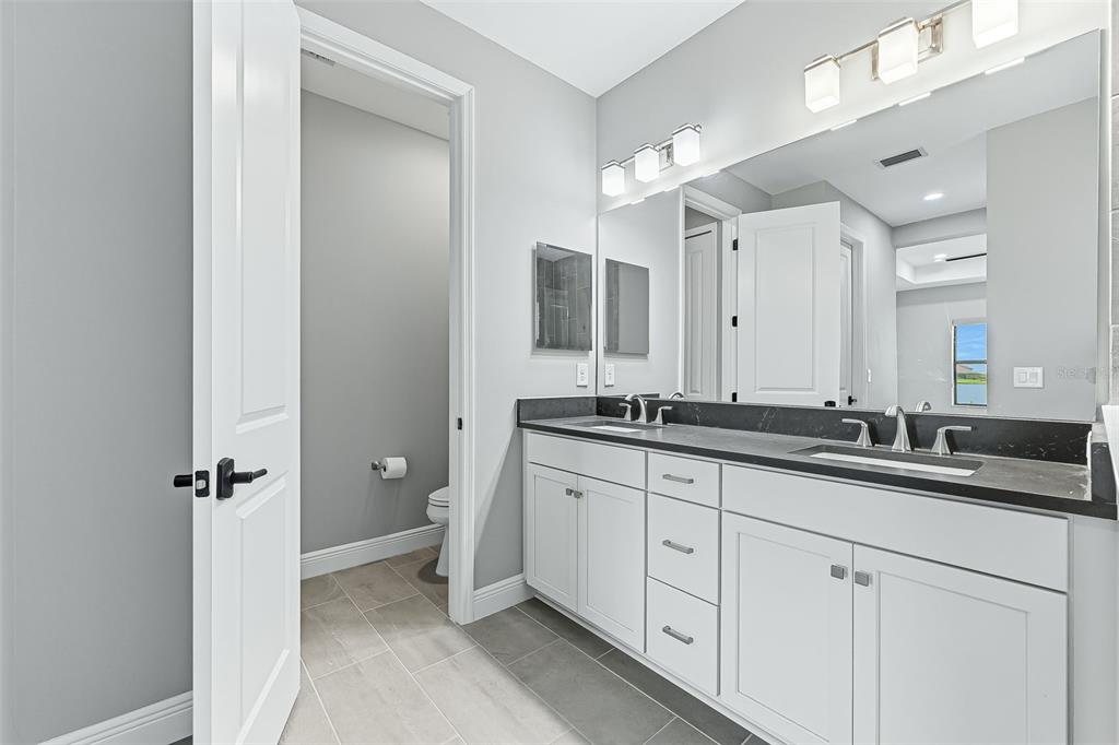4191 Pegasus Way Naples, FL 34120 - Photo 21 of 48 a bathroom with a double vanity sink and mirror