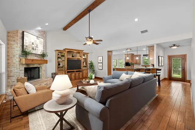 a living room with furniture kitchen view and a fireplace