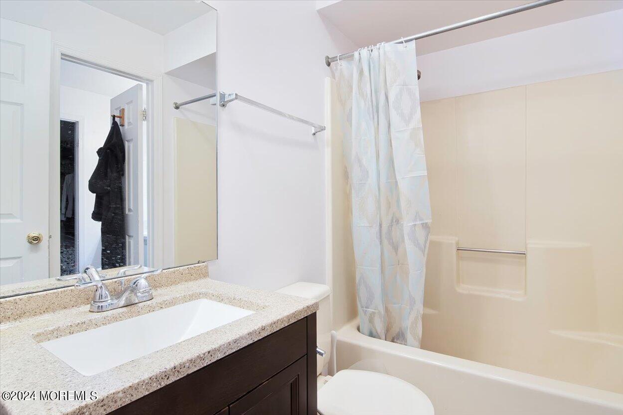 53 Racquet Road Wall, NJ 07719 - Photo 21 of 29 a bathroom with a granite countertop sink toilet and shower