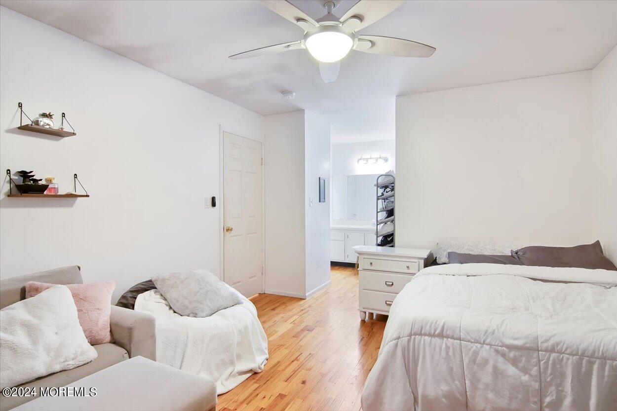 53 Racquet Road Wall, NJ 07719 - Photo 23 of 29 a bedroom with a bed and a chandelier