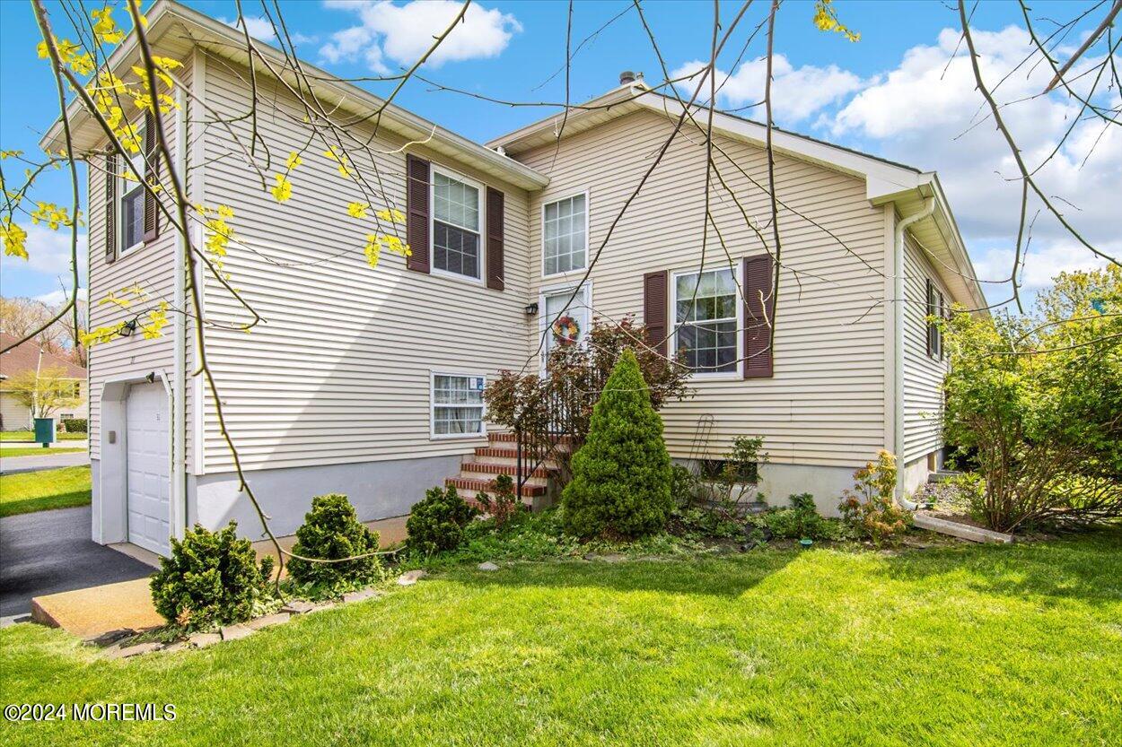 53 Racquet Road Wall, NJ 07719 - Photo 3 of 29 a view of a house with a yard and plants