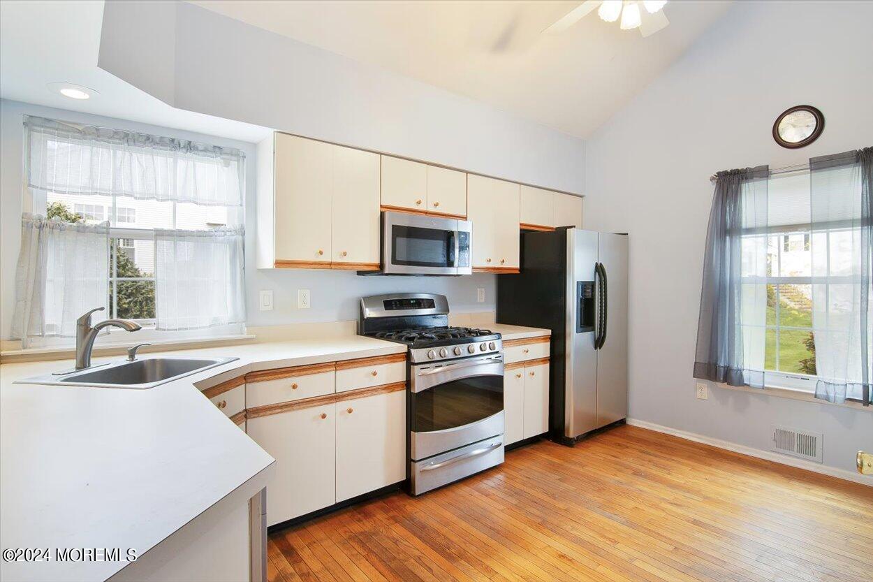 53 Racquet Road Wall, NJ 07719 - Photo 8 of 29 a kitchen with stainless steel appliances granite countertop a sink a stove a refrigerator with grey cabinets