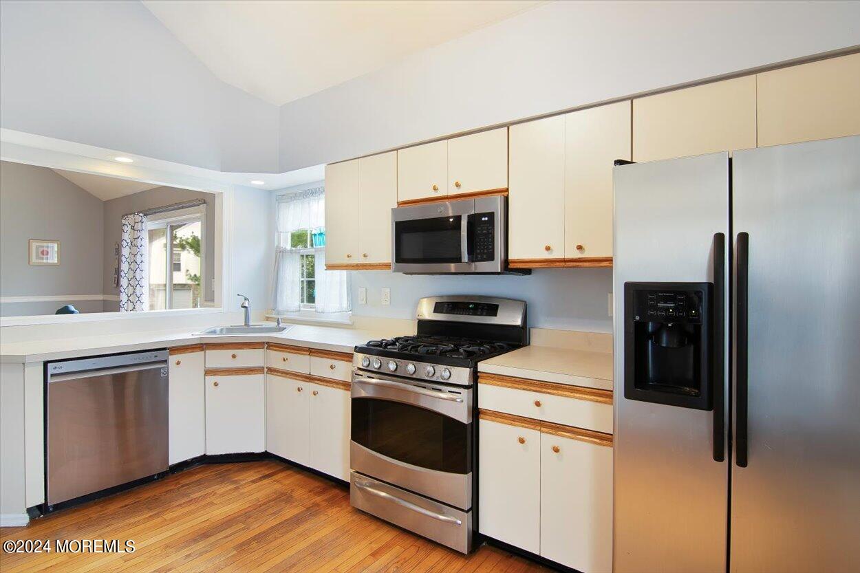 53 Racquet Road Wall, NJ 07719 - Photo 9 of 29 a kitchen with white cabinets and stainless steel appliances