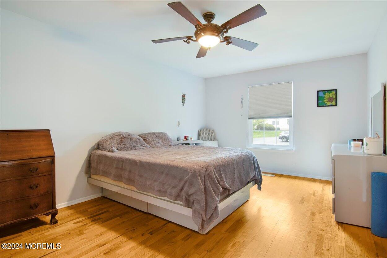 53 Racquet Road Wall, NJ 07719 - Photo 10 of 29 a bedroom with a bed and a chandelier