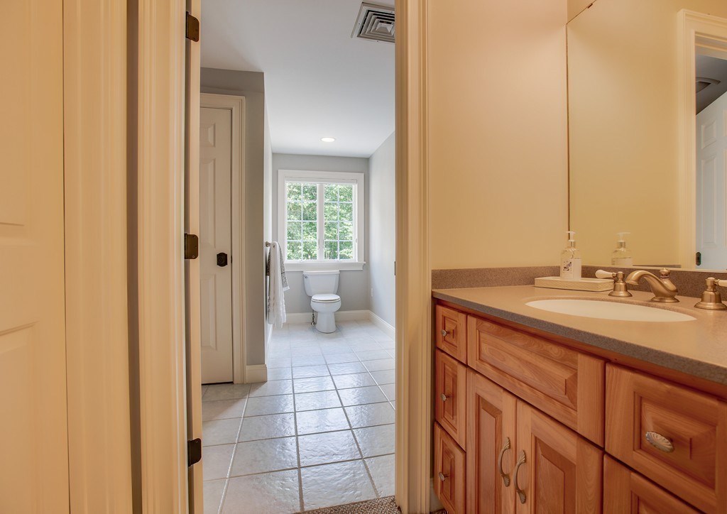 16 B Laurel Hollow Road Boxford, MA 01921 - Photo 24 of 39 a spacious bathroom with a sink a toilet and a mirror