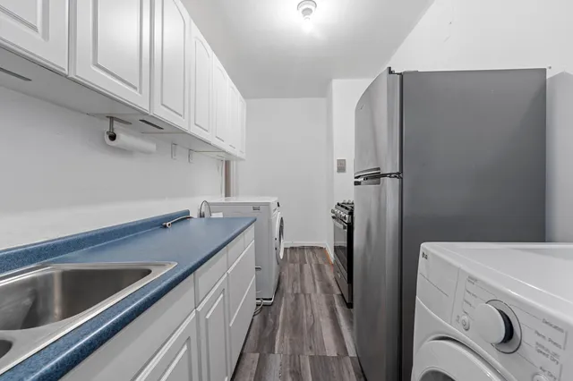 a kitchen with stainless steel appliances a refrigerator and a sink