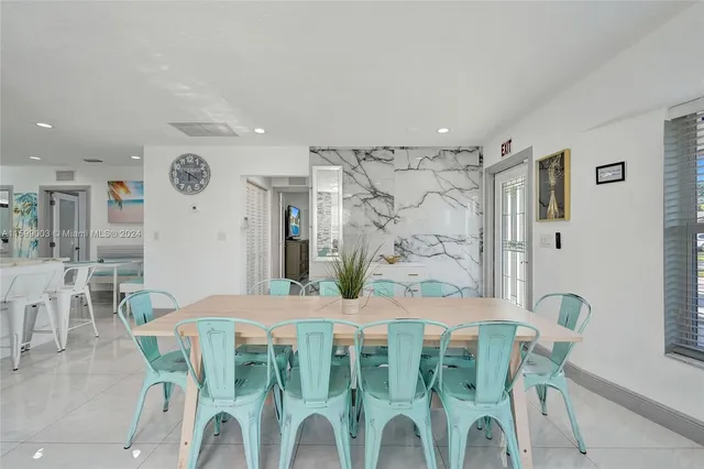 a living room with furniture and wall paintings