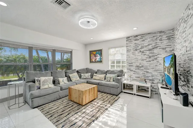 a bedroom with a bed and a television