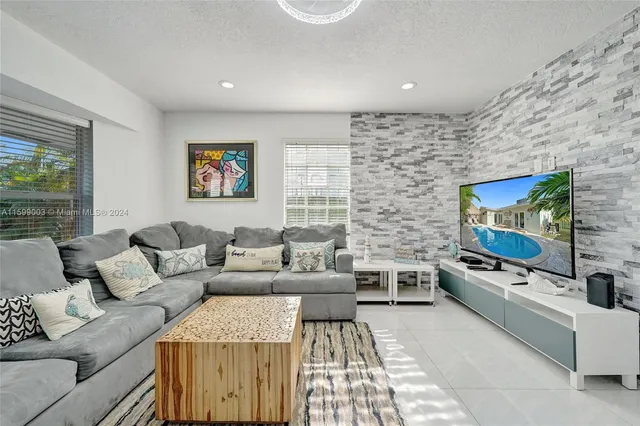 a kitchen with a sink a center island and stainless steel appliances