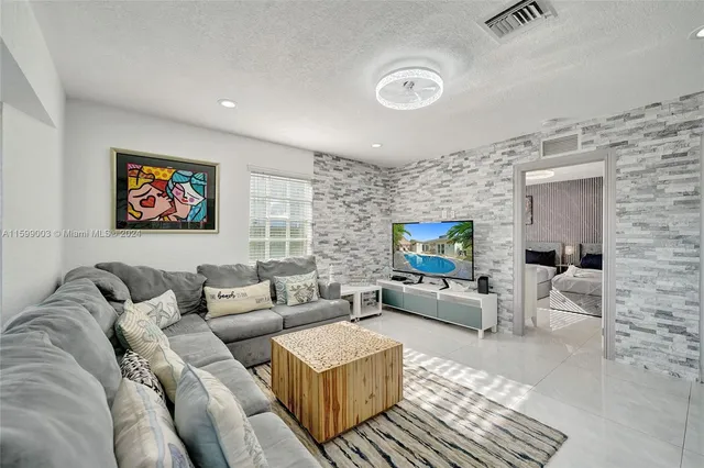 a kitchen with granite countertop white cabinets and stainless steel appliances