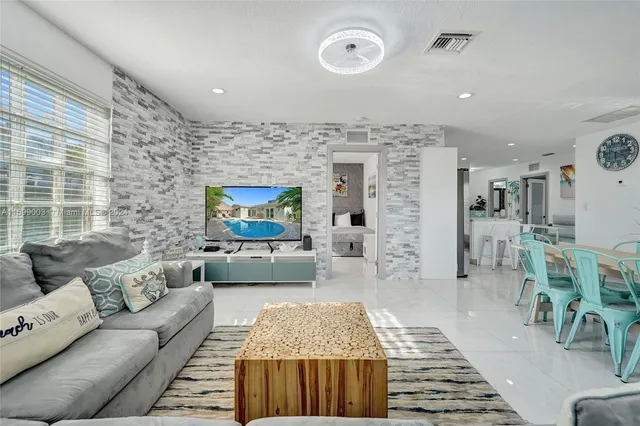 a kitchen with granite countertop a sink stainless steel appliances and white cabinets