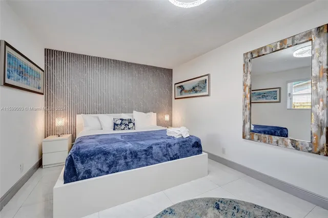 a en suite bathroom with a granite countertop sink and a mirror