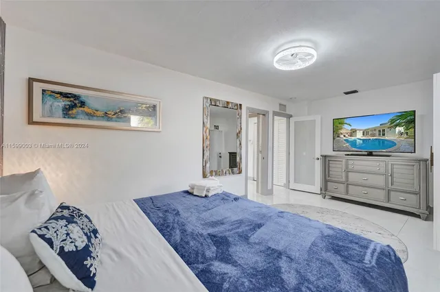 a bathroom with a toilet sink a mirror and shower