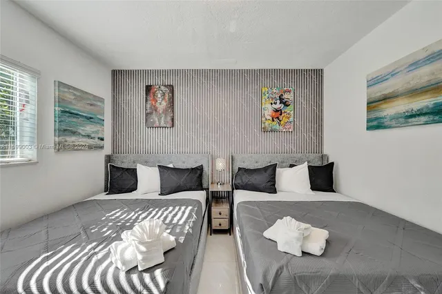 a spacious bedroom with a bed and a window