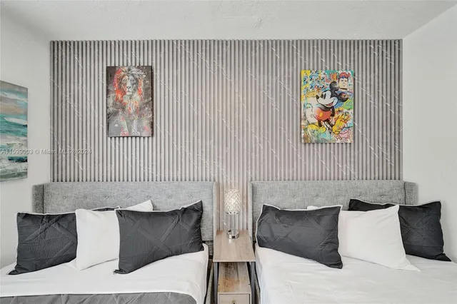 a spacious bedroom with a bed and a dresser