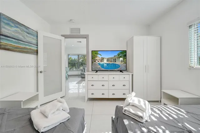 a bedroom with a bed and a television