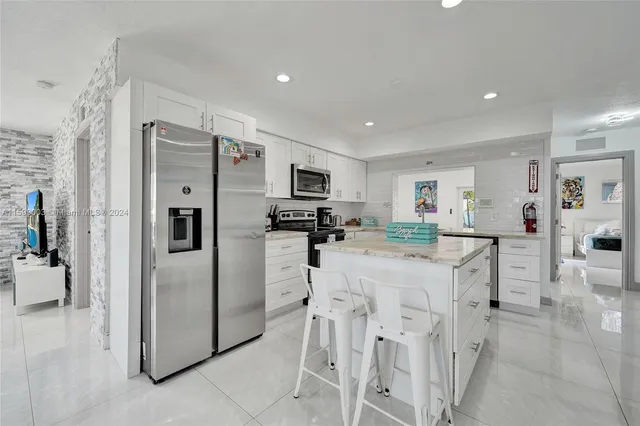 a bathroom with a double vanity sink mirror and shower