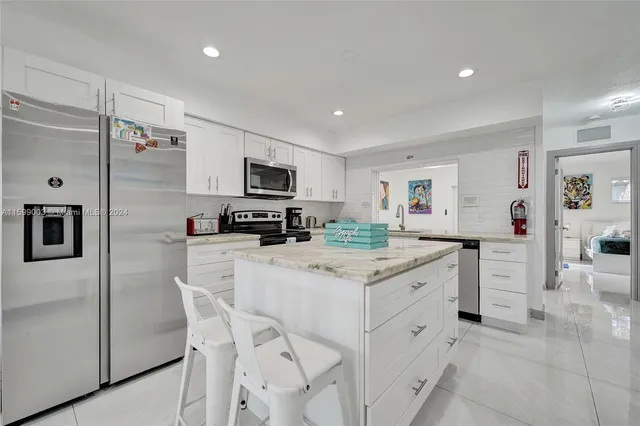 a bedroom with a bed and painting on the wall