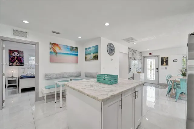 a living room with furniture and paintings on the wall