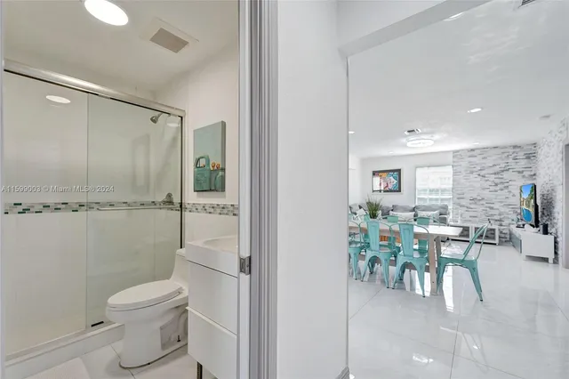 a view of a hallway with furniture and wooden floor