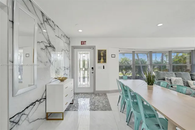 a bedroom with a large bed and a lamp on dresser
