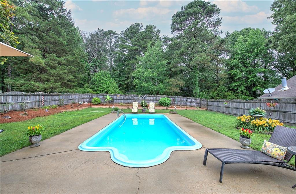 3637 Nebo Road Hiram, GA 30141 - Photo 60 of 63 a view of a swimming pool with a garden and chairs