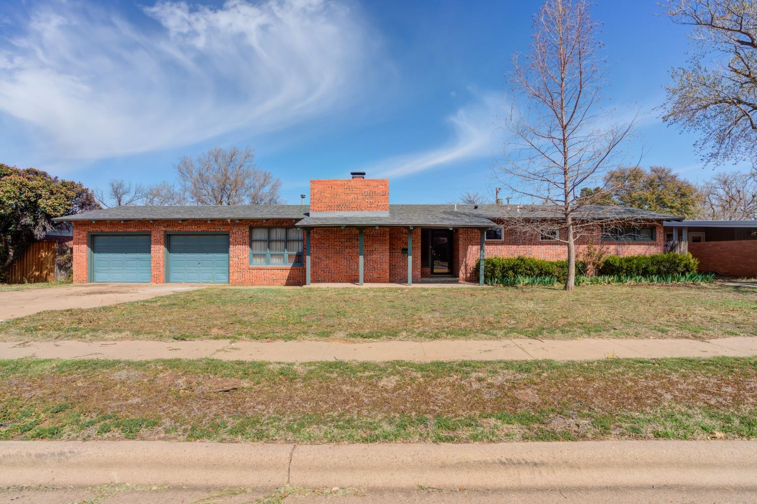 3410 40th Street Lubbock, TX 79413 - Photo 1 of 45 a front view of a house with a yard