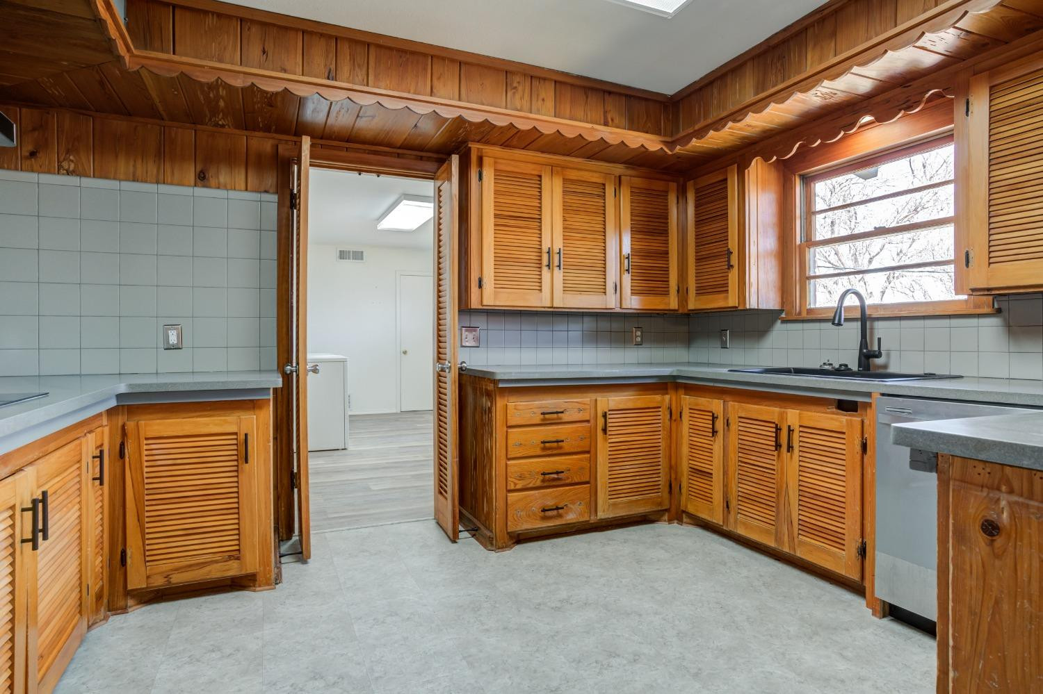 3410 40th Street Lubbock, TX 79413 - Photo 13 of 45 a kitchen with granite countertop cabinets and window