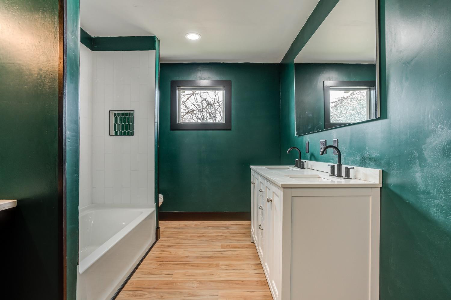 3410 40th Street Lubbock, TX 79413 - Photo 20 of 45 a bathroom with a sink and a mirror