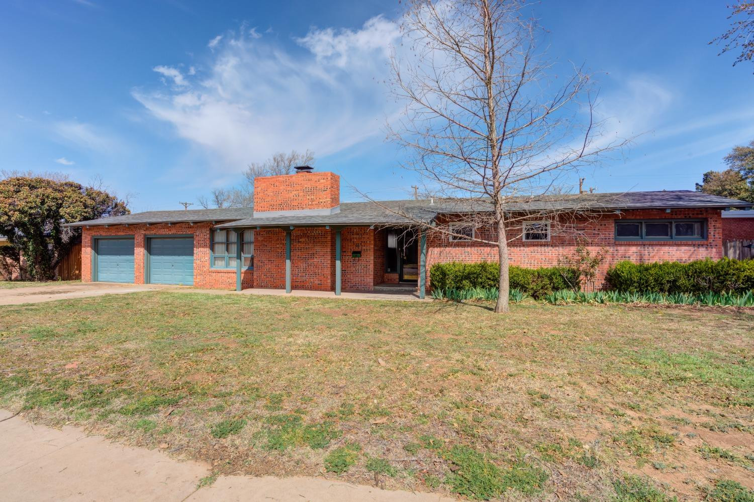 3410 40th Street Lubbock, TX 79413 - Photo 2 of 45 a front view of a building with a garden