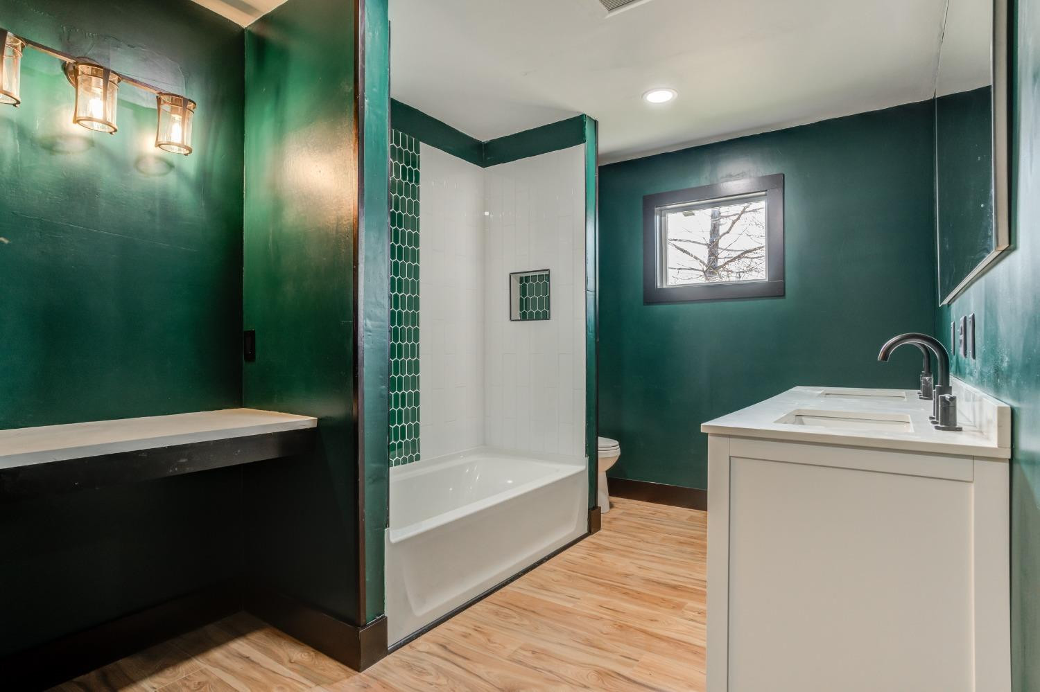 3410 40th Street Lubbock, TX 79413 - Photo 21 of 45 a bathroom with a sink a toilet and a mirror